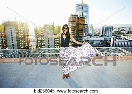 Asian woman dancing on urban rooftop View Large Photo Image Stock Photography - Asian woman dancing on urban rooftop. Fotosearch