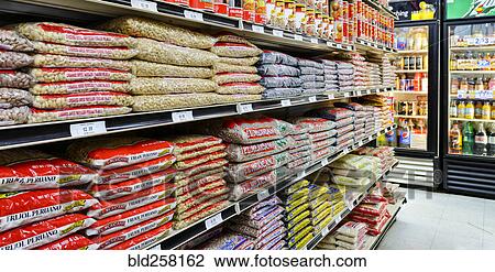 Stock Image - Bags of food on shelves of grocery store. Fotosearch
