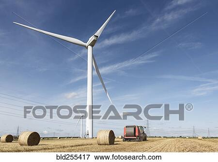 Bales of hay and tractor near wind turbine View Large Photo Image Stock Photo - Bales of hay and tractor near wind turbine. Fotosearch