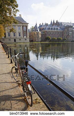 Bicycle and ornate Dutch buildings near pond View Large Photo Image Stock Photograph - Bicycle and ornate Dutch buildings near pond. Fotosearch