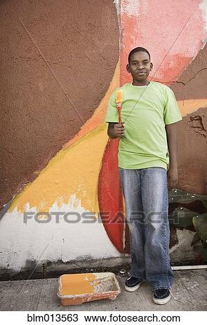 Black boy painting wall View Large Photo Image Stock Image - Black boy painting wall. Fotosearch