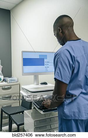 Stock Photograph - Black doctor using computer in hospital. Fotosearch