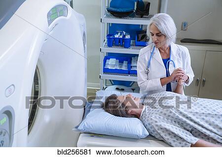 Stock Image - Black hospital technician wearing protective vest. Fotosearch