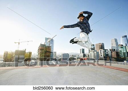 Black man dancing and jumping on urban rooftop View Large Photo Image Stock Image - Black man dancing and jumping on urban rooftop. Fotosearch