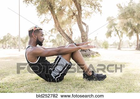 Black man doing sit-ups in park View Large Photo Image Stock Image - Black man doing sit-ups in park. Fotosearch