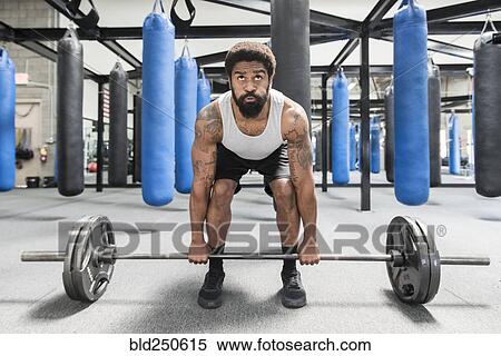 Black man lifting barbell in gymnasium View Large Photo Image Stock Photography - Black man lifting barbell in gymnasium. Fotosearch