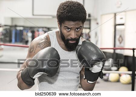 Stock Photo - Black man posing in boxing ring. Fotosearch
