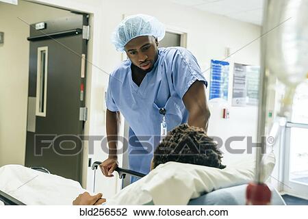 Black nurse talking to boy in hospital bed View Large Photo Image Stock Image - Black nurse talking to boy in hospital bed. Fotosearch