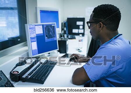 Stock Photograph - Black nurse using computer. Fotosearch