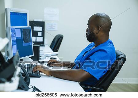 Stock Photography - Black nurse using computer. Fotosearch