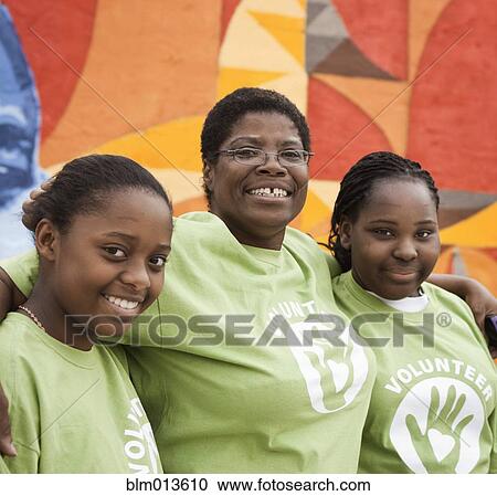 Black volunteers hugging View Large Photo Image Stock Image - Black volunteers hugging. Fotosearch