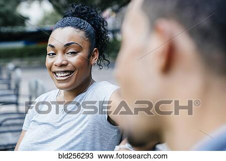 Stock Image - Black woman laughing with man. Fotosearch