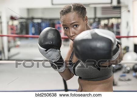 Stock Photo - Black woman posing in boxing ring. Fotosearch