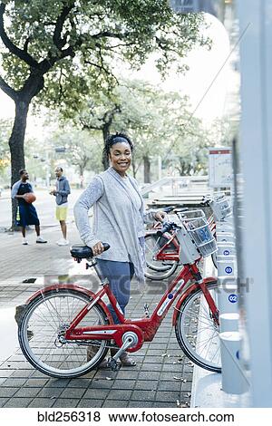 Black woman posing with rental bicycle View Large Photo Image Stock Photo - Black woman posing with rental bicycle. Fotosearch