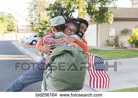 Black woman soldier hugging man and daughter View Large Photo Image Picture - Black woman soldier hugging man and daughter. Fotosearch