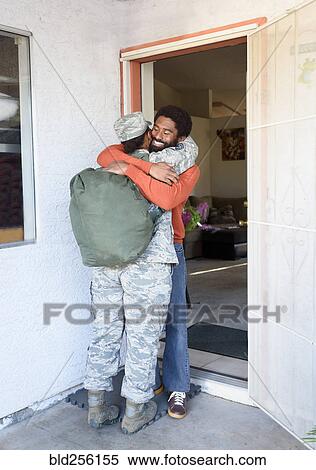 Black woman soldier hugging man in doorway View Large Photo Image Stock Photography - Black woman soldier hugging man in doorway. Fotosearch