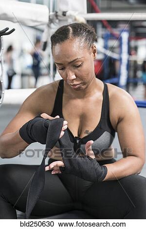 Black woman wrapping hand in gymnasium View Large Photo Image Stock Image - Black woman wrapping hand in gymnasium. Fotosearch