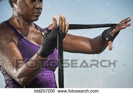 Black woman wrapping hands for boxing View Large Photo Image Stock Image - Black woman wrapping hands for boxing. Fotosearch