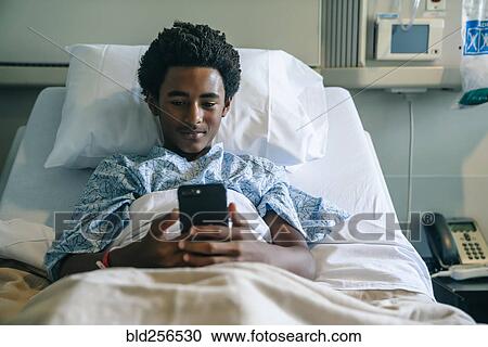 Blackboard texting on cell phone in hospital bed View Large Photo Image Stock Image - Blackboard texting on cell phone in hospital bed. Fotosearch