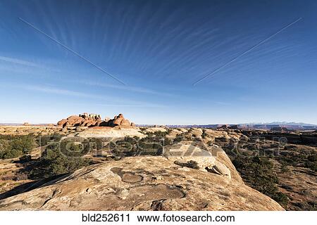 Stock Image - "Blue sky over rocks in desert, Moab, Utah, United States". Fotosearch