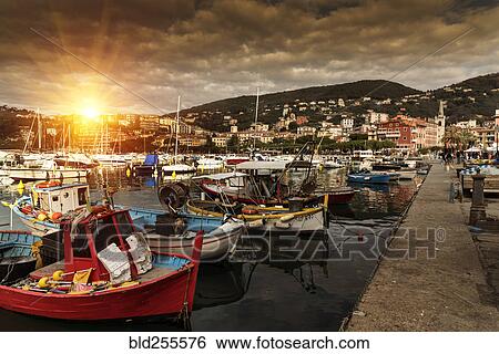 Stock Photograph - Boats at marina at sunset. Fotosearch