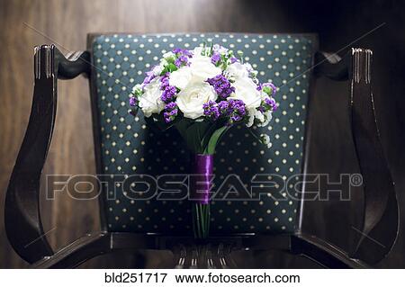Bouquet of flowers on chair View Large Photo Image Stock Photo - Bouquet of flowers on chair. Fotosearch