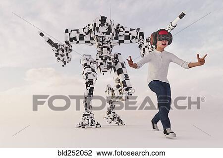 Stock Image - Boy wearing virtual reality goggles imitating robot soldier. Fotosearch