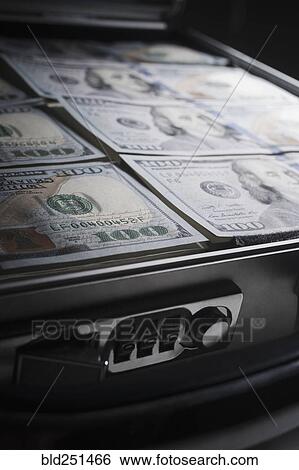 Briefcase filled with the money View Large Photo Image Stock Photograph - Briefcase filled with the money. Fotosearch