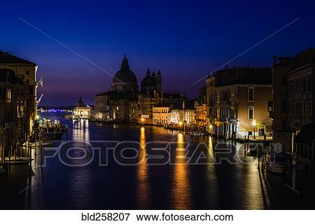 Stock Photo - Buildings along canal at night, Venice, Italy. Fotosearch