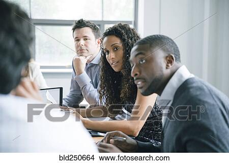 Picture - Business people listening in meeting. Fotosearch