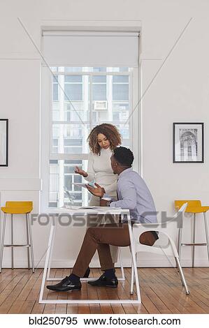 Business people reading notepad and talking View Large Photo Image Stock Photography - Business people reading notepad and talking. Fotosearch