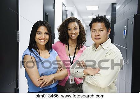 Stock Photograph - Business people standing in server room. Fotosearch