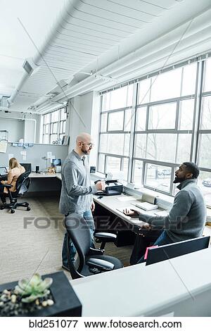 Business people talking in office View Large Photo Image Stock Photo - Business people talking in office. Fotosearch