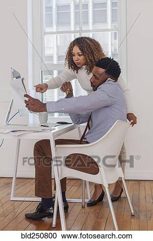 Business people talking on cell phone and reading notepad View Large Photo Image Stock Image - Business people talking on cell phone and reading notepad. Fotosearch