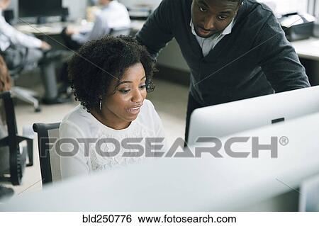 Stock Photograph - Business people using computer in office. Fotosearch