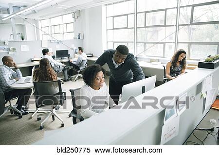Stock Photography - Business people using computer in office. Fotosearch