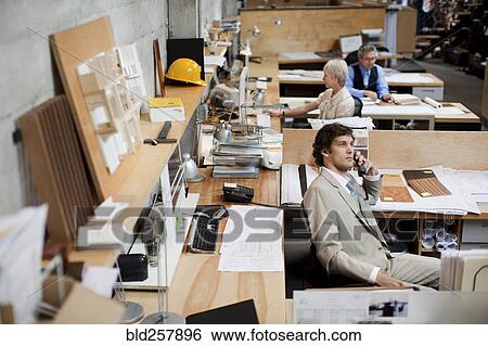 Stock Photograph - Business people working in busy office. Fotosearch