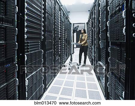 Business people working in server room View Large Photo Image Stock Image - Business people working in server room. Fotosearch