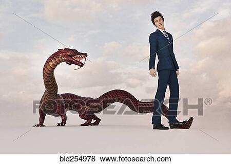 Businessman standing on tail of dragon View Large Photo Image Stock Photo - Businessman standing on tail of dragon. Fotosearch