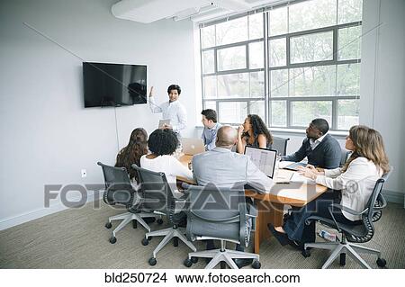 Businessman talking near visual screen in meeting View Large Photo Image Picture - Businessman talking near visual screen in meeting. Fotosearch