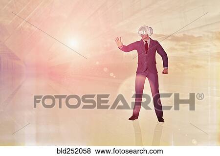 Stock Photo - Businessman wearing virtual reality goggles. Fotosearch