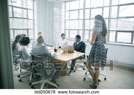 Businesswoman talking behind window in meeting View Large Photo Image Stock Photo - Businesswoman talking behind window in meeting. Fotosearch