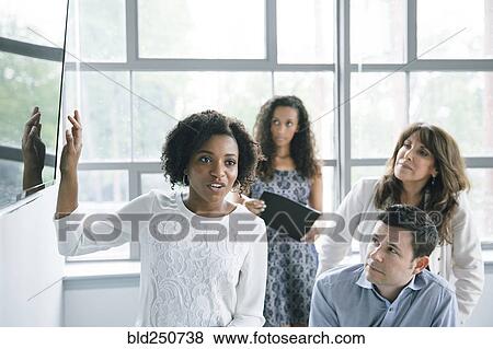 Businesswoman talking near visual screen in meeting View Large Photo Image Stock Photo - Businesswoman talking near visual screen in meeting. Fotosearch