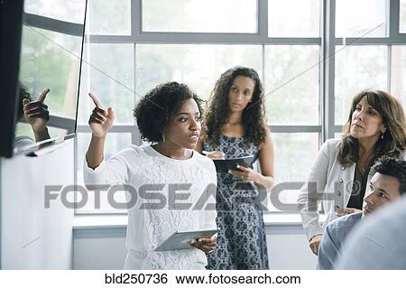 Businesswoman talking near visual screen in meeting View Large Photo Image Stock Photograph - Businesswoman talking near visual screen in meeting. Fotosearch