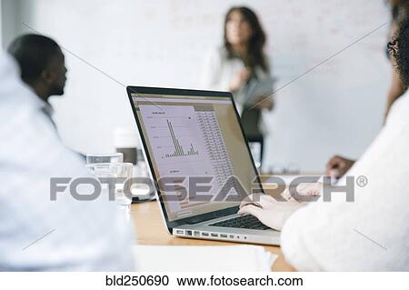 Businesswoman typing on laptop in meeting View Large Photo Image Stock Image - Businesswoman typing on laptop in meeting. Fotosearch