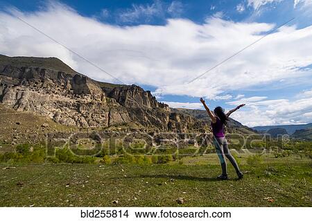 Picture - Carefree Caucasian woman admiring mountains. Fotosearch