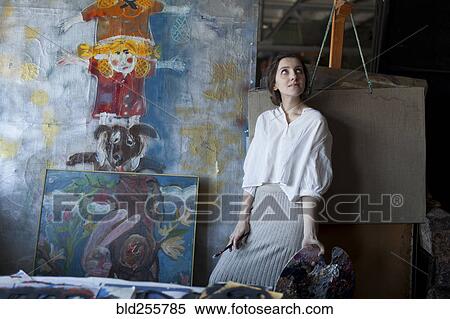 Stock Photography - Caucasian artist holding paintbrush and palette. Fotosearch