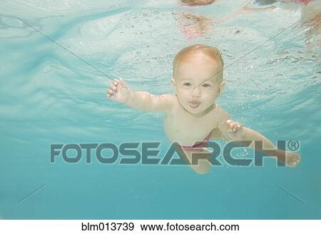 Stock Photo - Caucasian baby swimming underwater. Fotosearch
