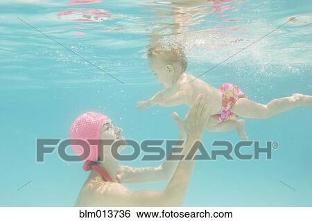 Stock Photograph - Caucasian baby swimming underwater. Fotosearch