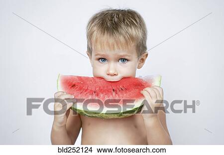 Caucasian boy biting watermelon slice View Large Photo Image Picture - Caucasian boy biting watermelon slice. Fotosearch